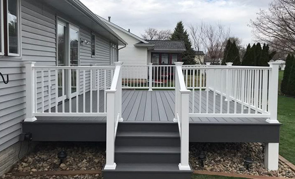 White deck with railing and steps leading down.