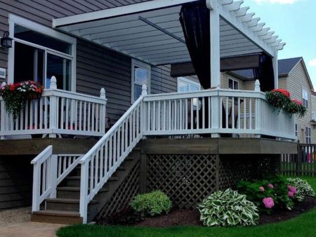 Deck with white railing, stairs, and flower pots