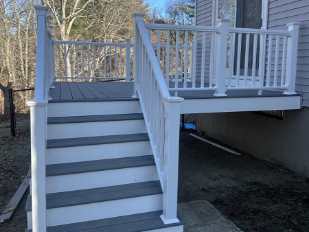 White stairs leading to a deck with a railing