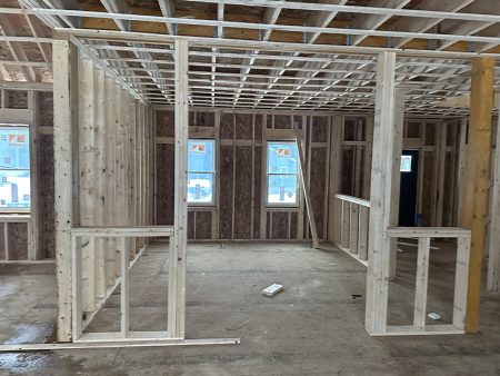 Framed walls and unfinished interior of a house.