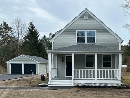 Newly built house with a garage and a front porch