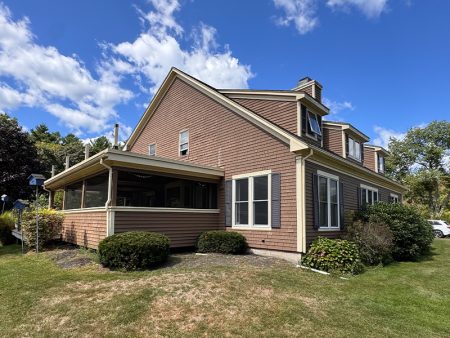Side view of a house with garden and screened porch