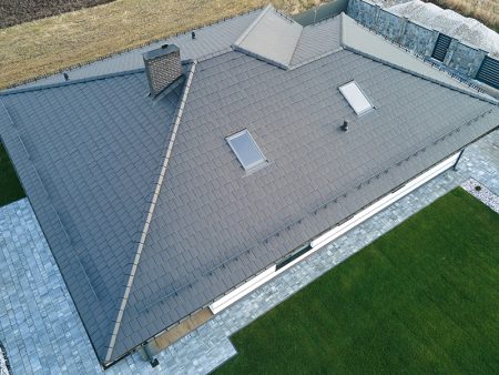 Aerial view of private house with ceramic shingles covered roof top.