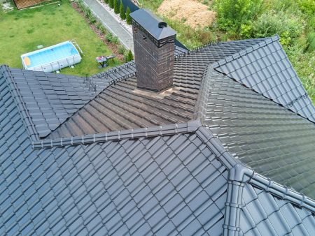 Closeup of house roof top covered with shiny ceramic shingles