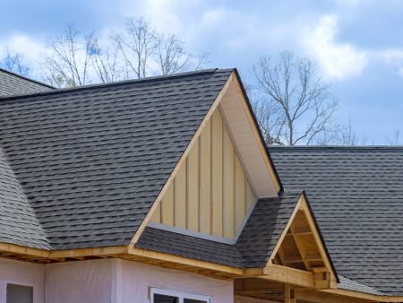 On newly constructed home, overlapping asphalt shingles are seen on roof