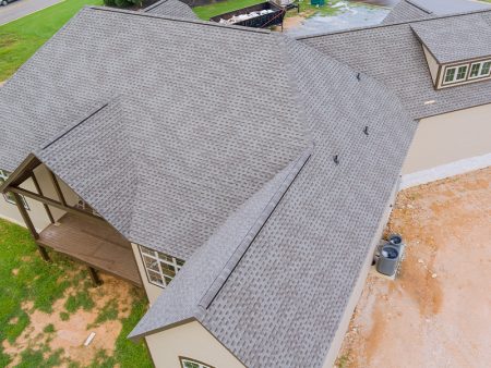 Rubber asphalt roof shingles are being used to cover construction roof of a new house