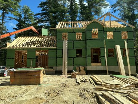 Construction site with framed walls and roof being built