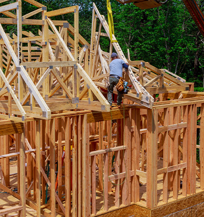 New wooden house from natural materials under construction. Close-up detail of attic roof frame